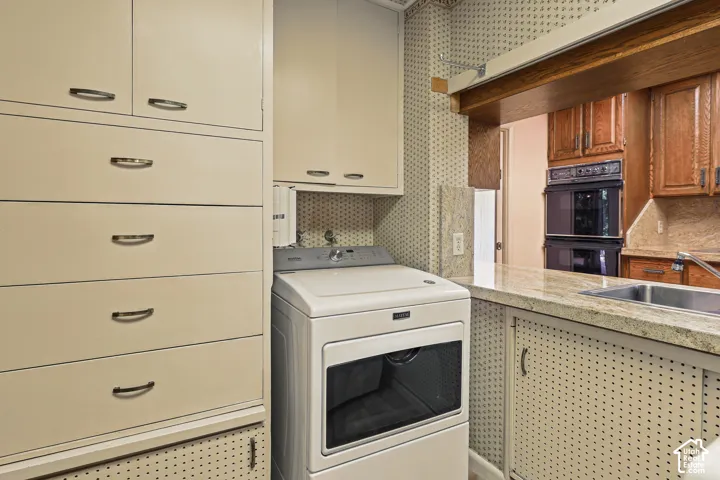 Central area washer and dryer with pass through to kitchen.