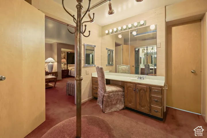 Walk in closet with makeup table.