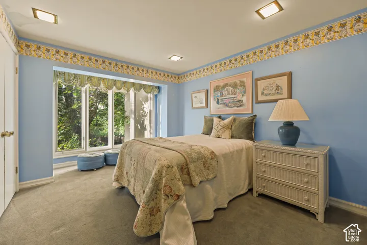 Main floor second bedroom with large view windows.