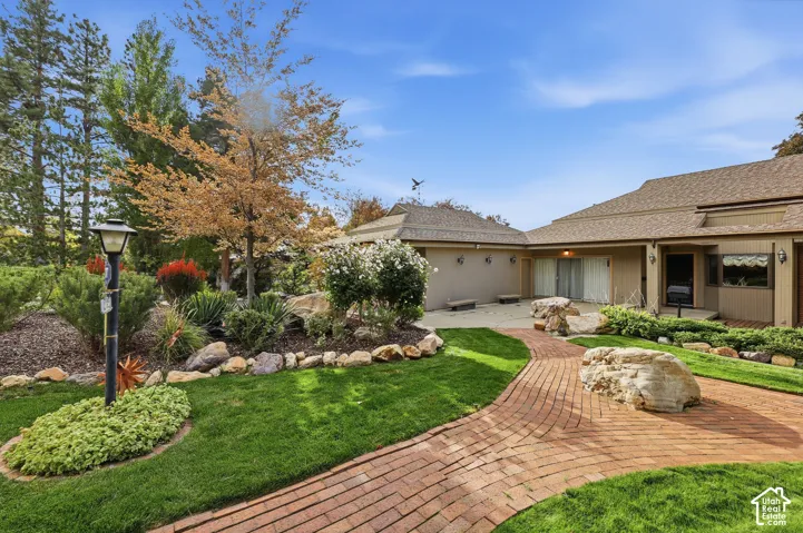 Charming brick paver pathways around entryway.