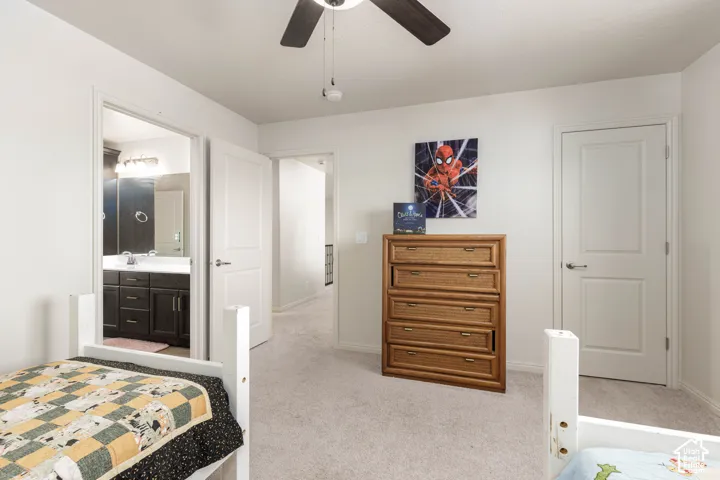 Bedroom featuring neutral carpeting, a ceiling fan, and multi-panel interior doors