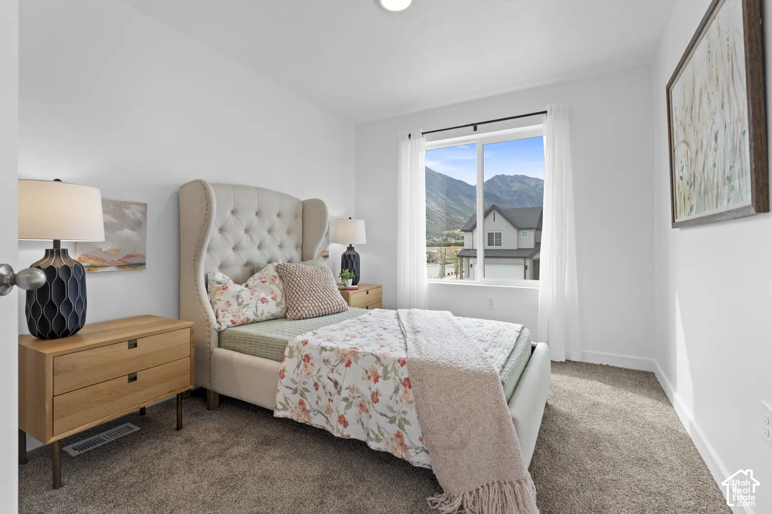 Bedroom featuring wall-to-wall carpeting, a dual-pane window, and a prominent mountain backdrop