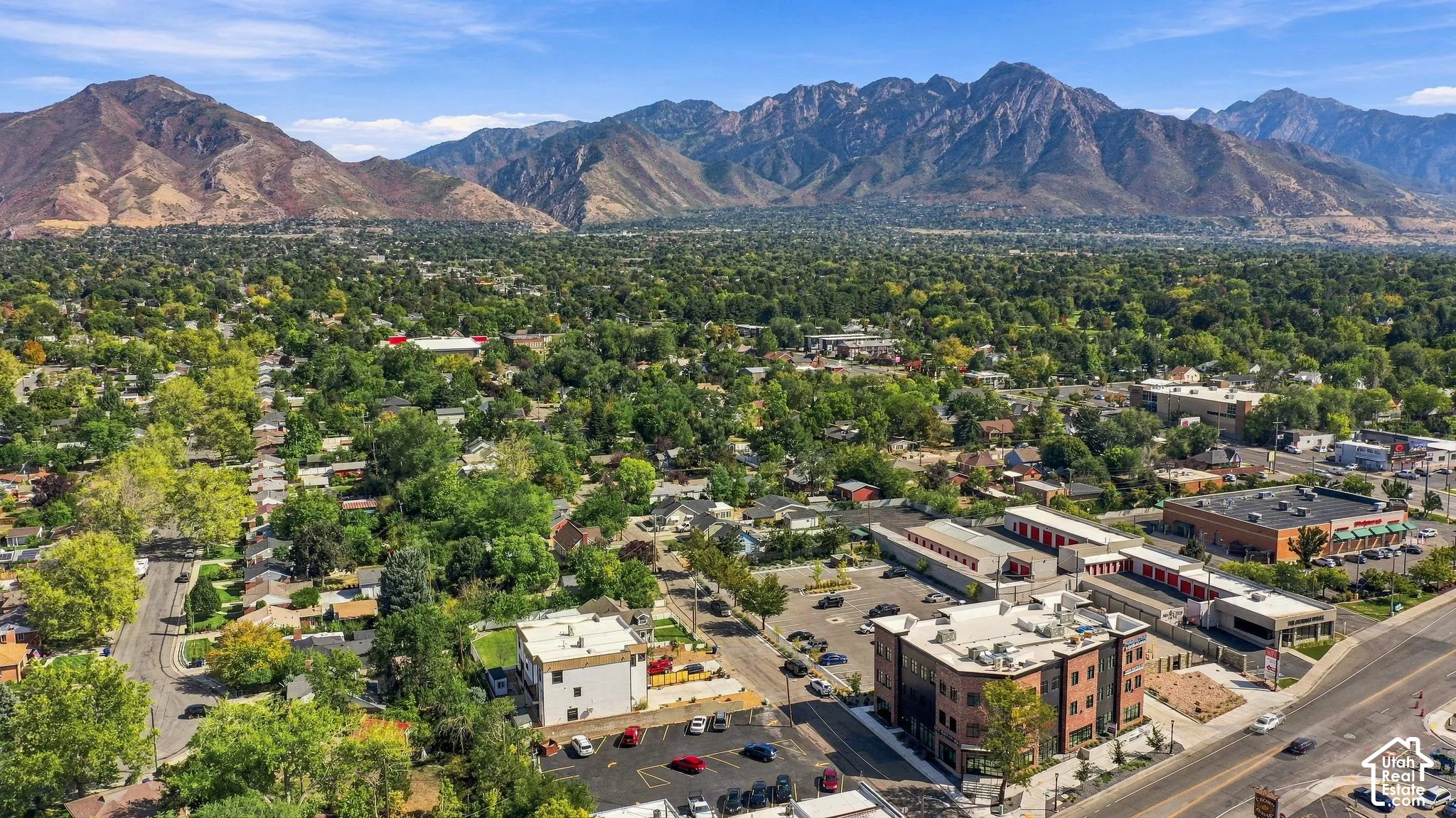 Expansive urban landscape set against a prominent mountain range