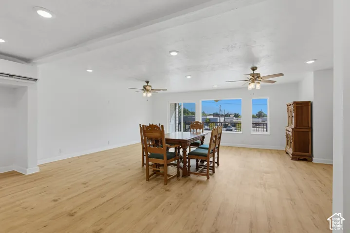 Wood-finish flooring, recessed lighting, ceiling fans, and multiple windows