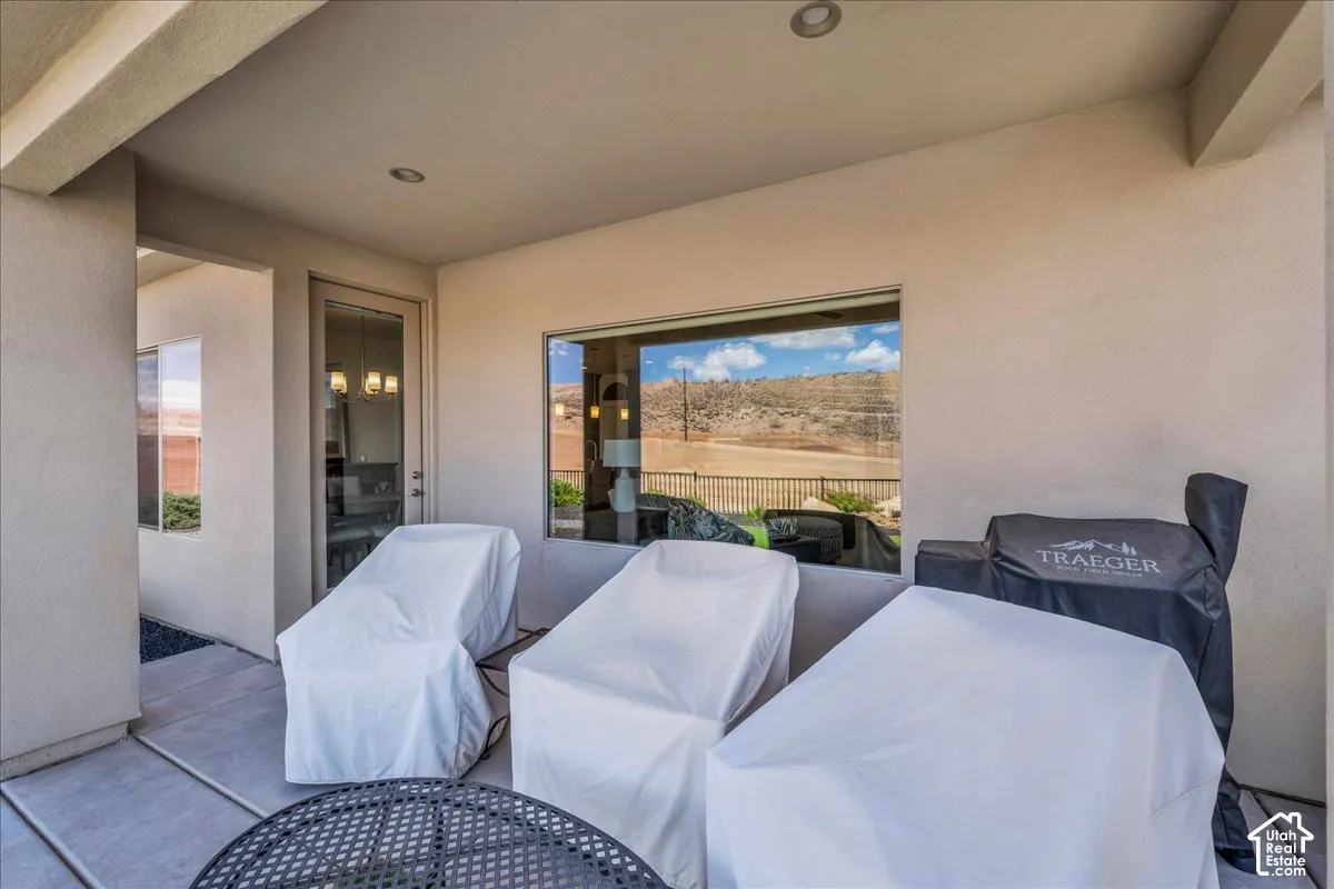 Covered patio featuring concrete flooring, recessed lighting, and a large picture window