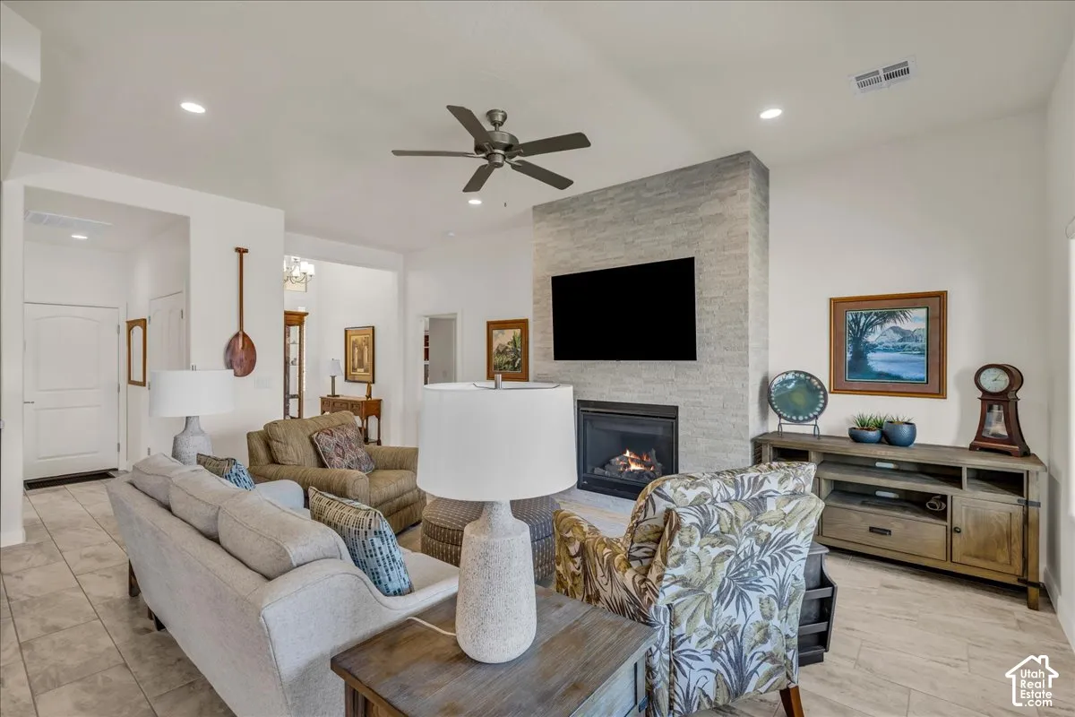 Fireplace featuring a full-height stone surround, ceramic tile flooring, recessed lighting, and a ceiling fan