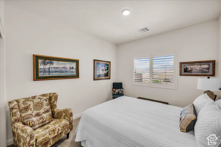 Neutral-toned room featuring wall-to-wall carpeting, high ceilings, and recessed lighting, finished with white interior shutters