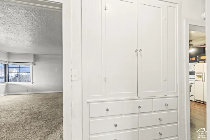Built-in floor-to-ceiling cabinetry featuring multi-drawer storage and white finish hardware