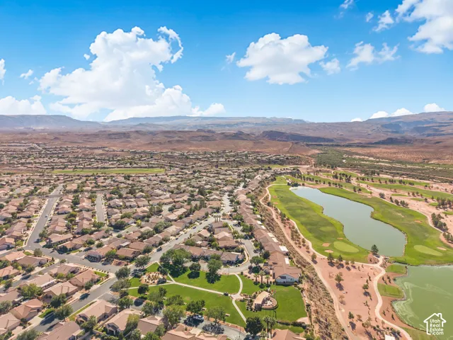 Aerial perspective featuring proximity to a golf course, expansive water features, desert landscape, and mountain terrain