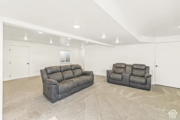 Neutral wall-to-wall carpeting, recessed ceiling lighting, and solid-core interior doors with shaker-style detailing