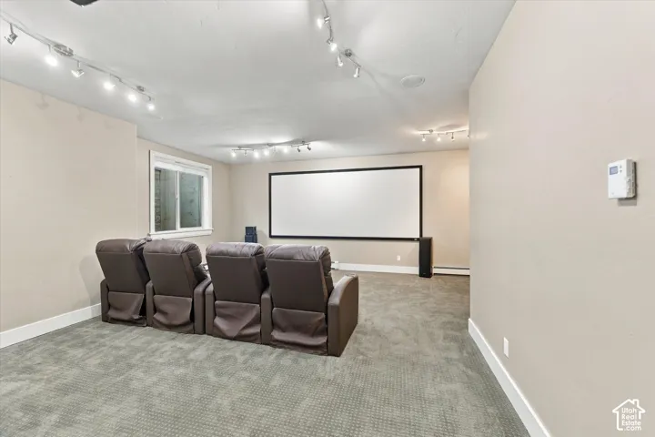 Large projection screen, multi-point track lighting, and wall-to-wall carpeting