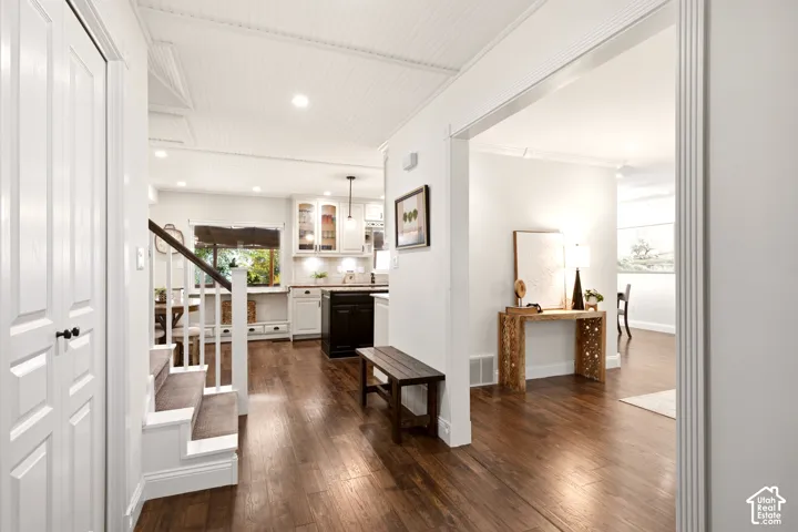 Entry featuring wood-finish flooring, beadboard ceiling, recessed lighting, and a staircase with a white railing and handrail