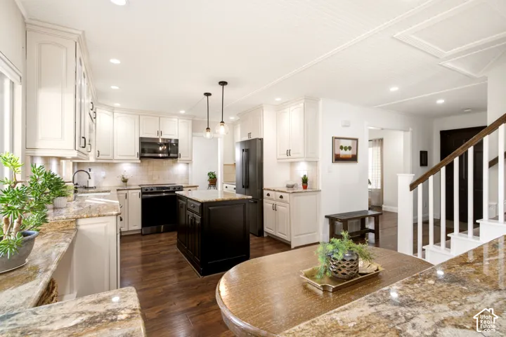 Kitchen featuring off-white shaker cabinetry, a contrasting dark-toned kitchen island, stone countertops, wood-finish flooring, and a beadboard ceiling