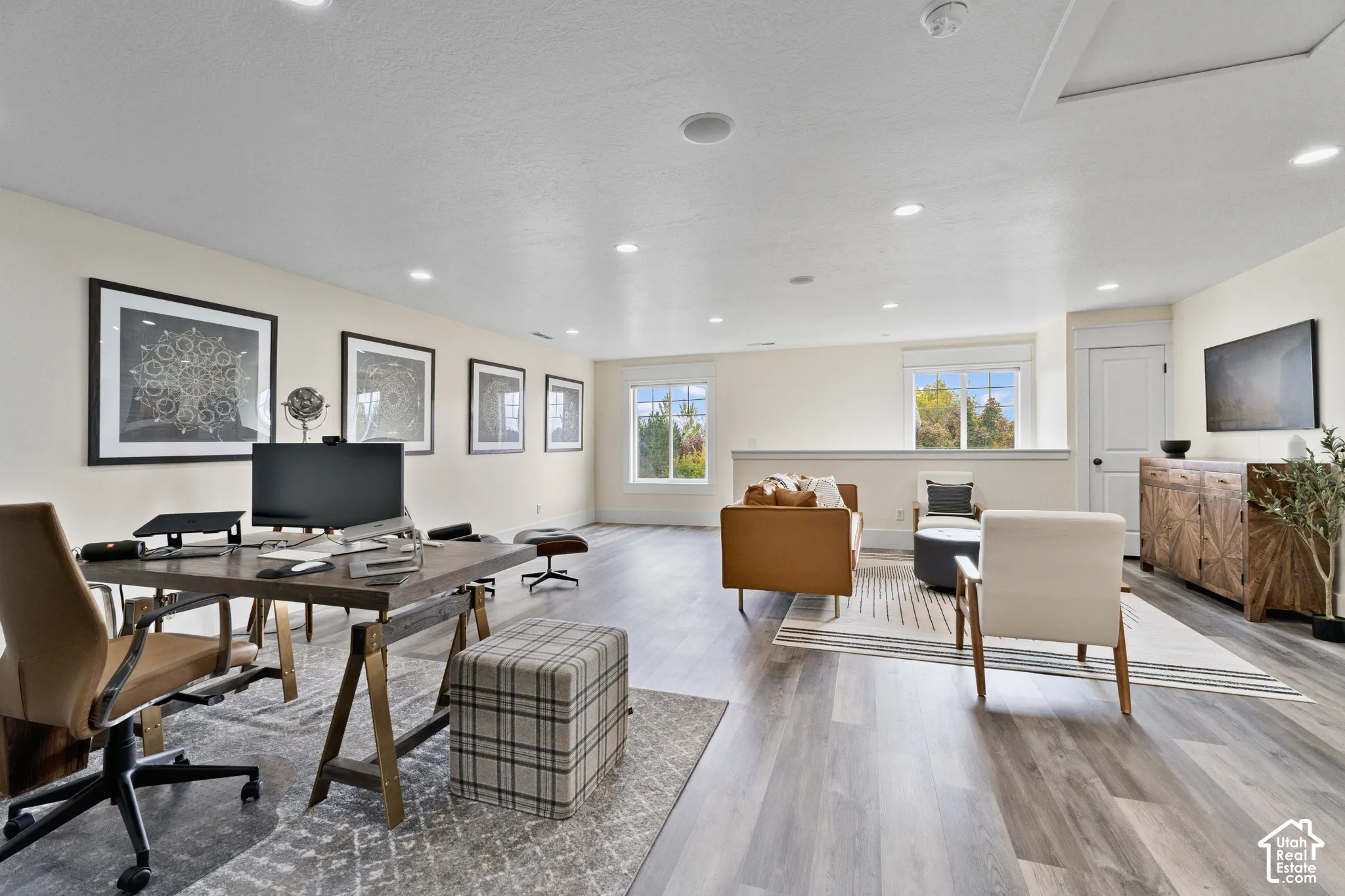Open-concept space featuring wood-finish flooring, recessed lighting, and expansive windows