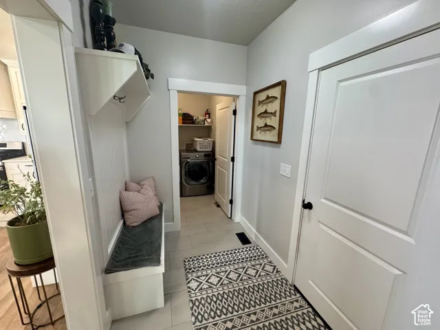 Built-in hall tree with bench seating, shaker-style interior doors, and tile flooring