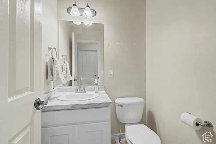 Vanity with a white oval undermount sink, a chrome faucet, and a wall-mounted mirror
