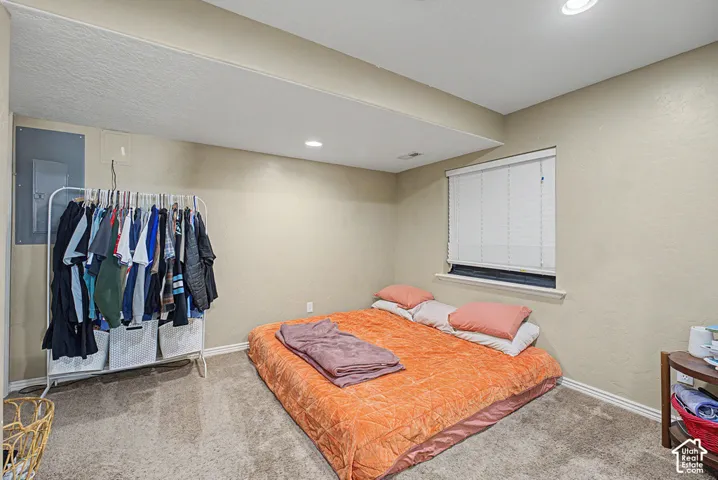 Carpeted flooring, neutral wall paint, recessed lighting, and a window with blinds