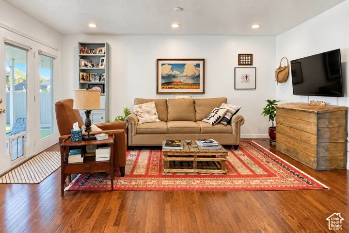 Wood-finish flooring, recessed ceiling lighting, and built-in floor-to-ceiling shelving