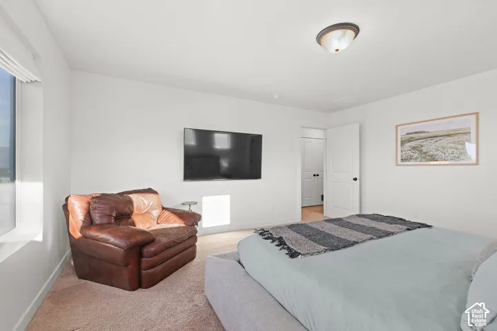 Neutral interior with wall-to-wall carpeting, recessed ceiling lighting, and a solid-core interior door