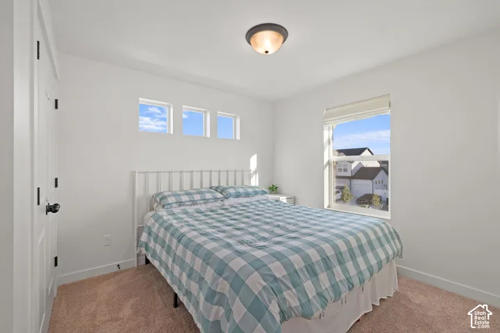 Neutral-toned interior featuring carpeted flooring, a recessed window, three clerestory windows, and a flush-mount ceiling light fixture