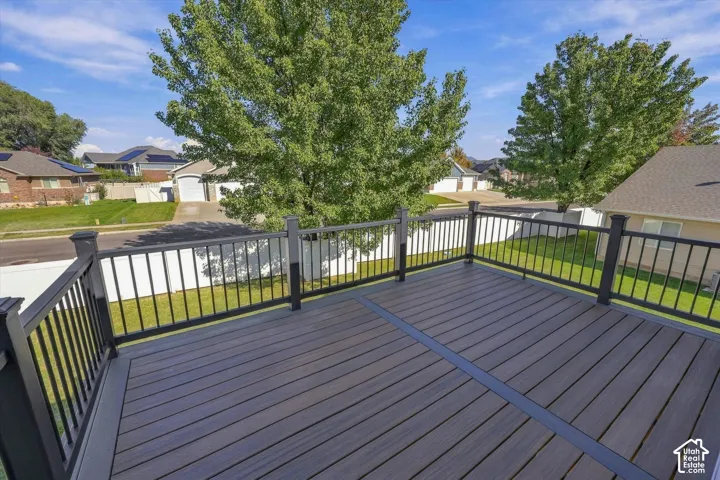 Elevated deck featuring composite decking, a dark metal balustrade, and a contrasting perimeter border