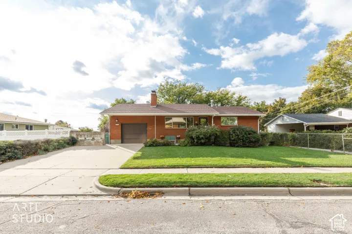 Single-story brick exterior featuring an attached one-car garage, pitched shingle roof, concrete driveway, and front lawn