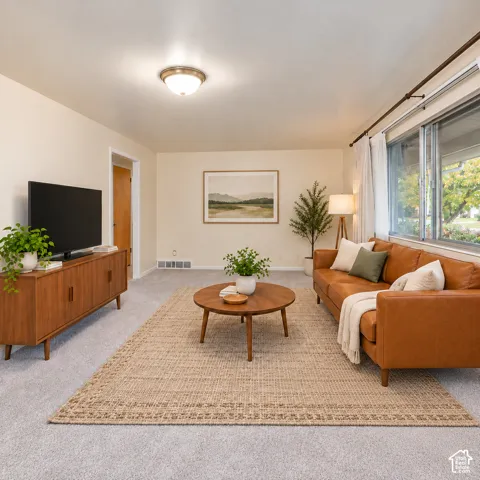 Neutral-toned carpeting, oversized windows, and a flush-mount ceiling light fixture