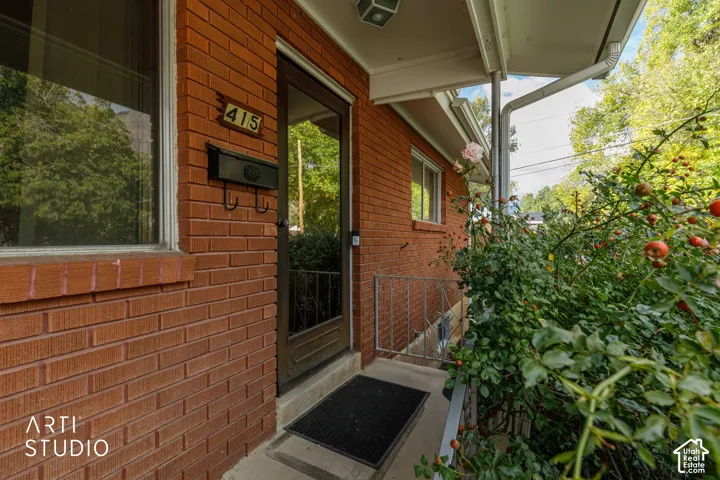 Exterior entrance featuring a red brick fa