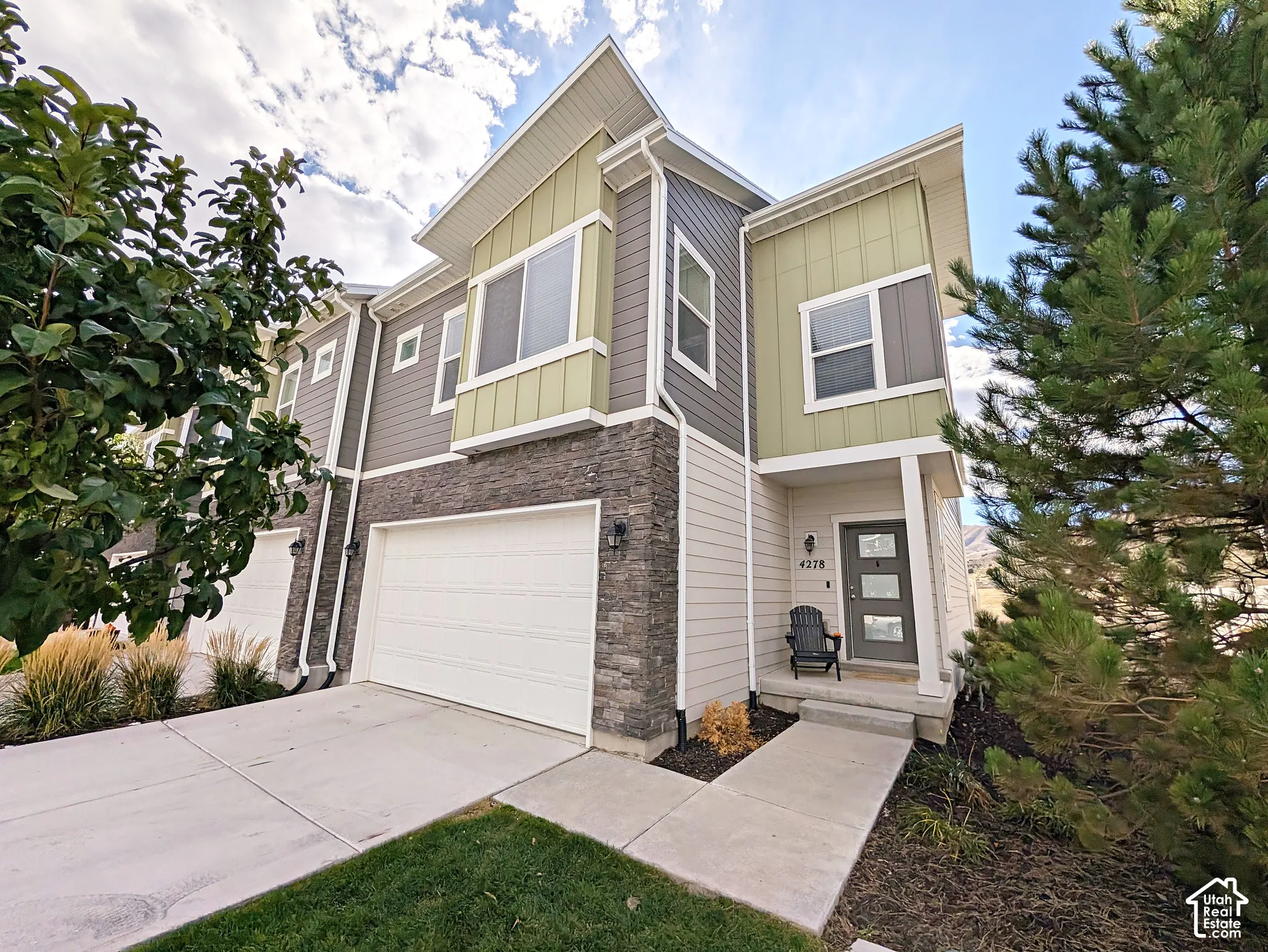 Modern facade featuring multi-tone siding and stone accents