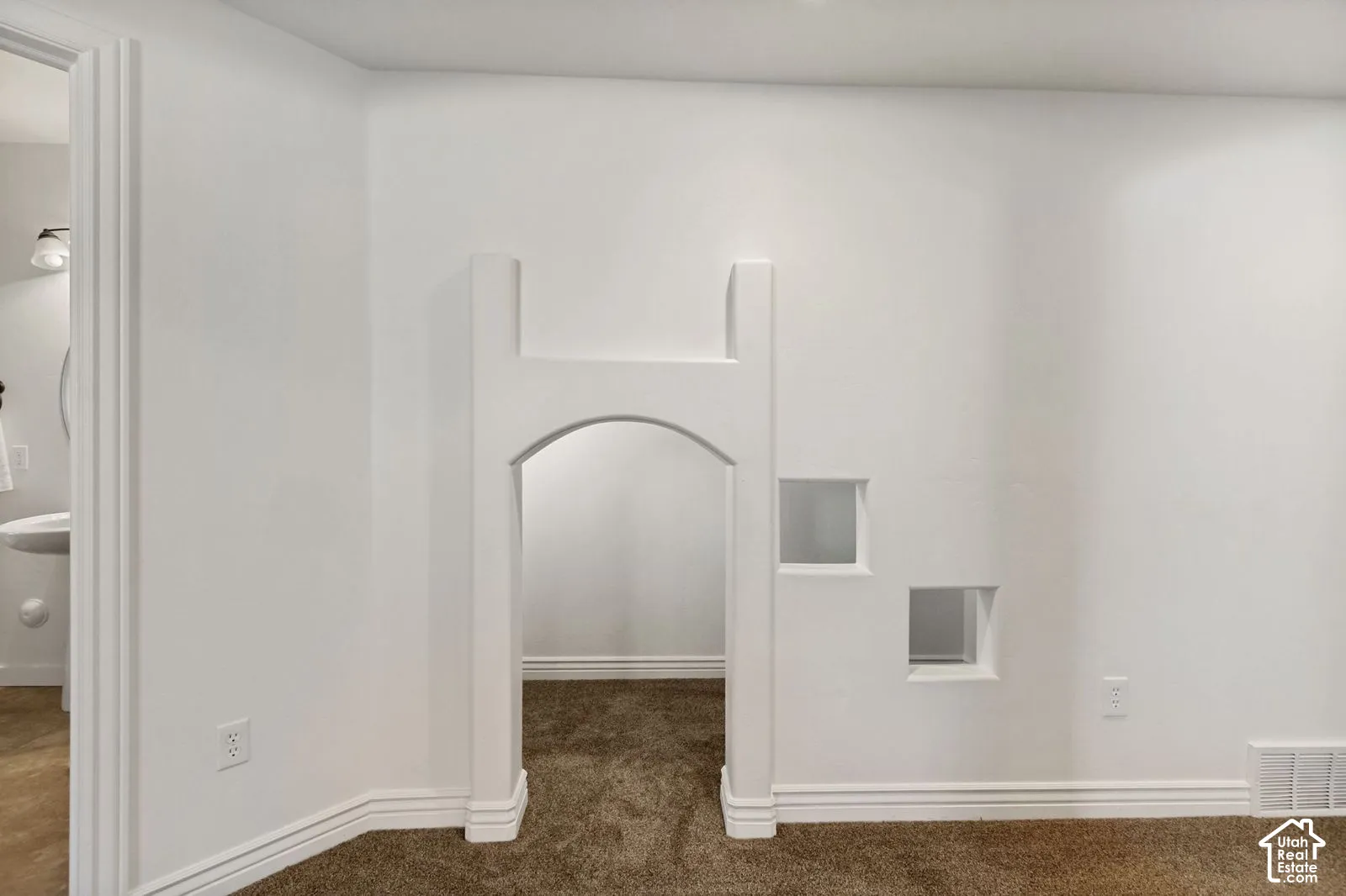 Custom interior wall featuring a structural arched opening and two integrated square pass-throughs