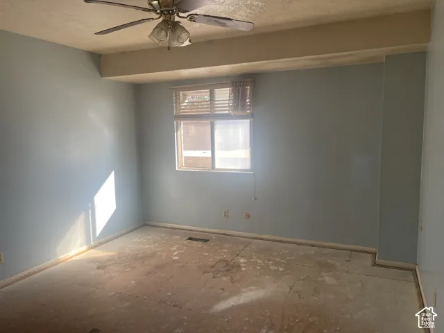 Room featuring a central ceiling fan with integrated lighting and a sliding window equipped with horizontal blinds