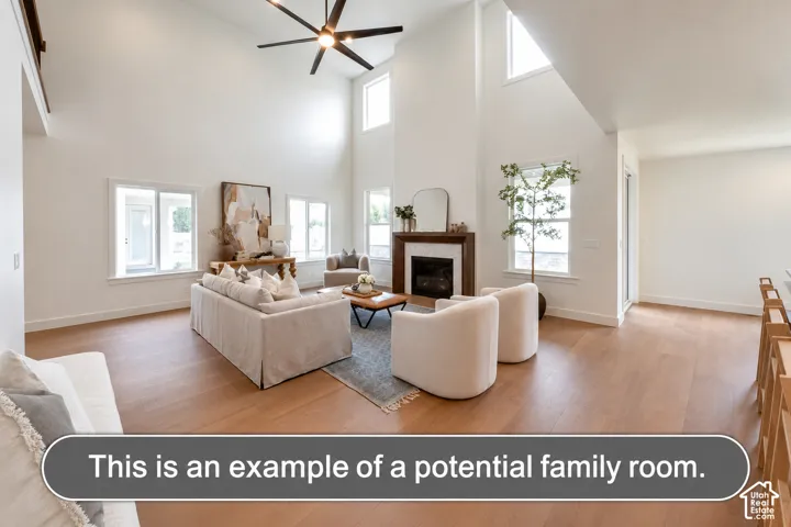Vaulted ceilings, wood-finish flooring, fireplace with a custom mantel, multi-pane windows, and a large multi-blade ceiling fan