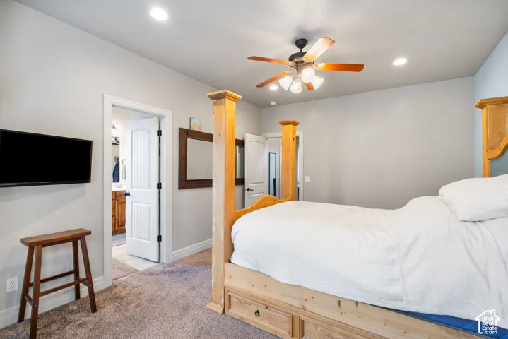 Neutral wall tones, carpeted flooring, recessed lighting, and a multi-blade ceiling fan with integrated light fixture
