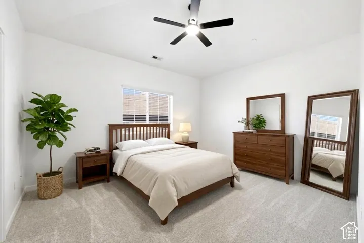 Vaulted ceilings featuring a multi-blade ceiling fan and neutral wall-to-wall carpeting