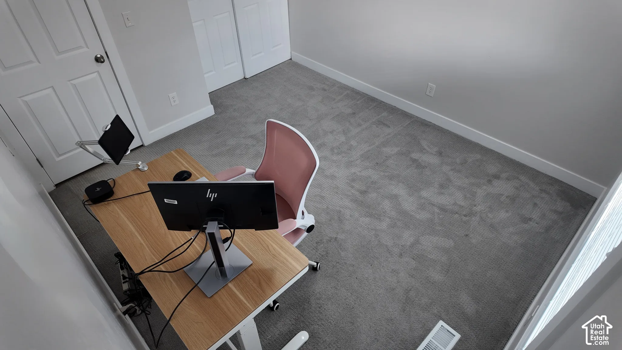 Neutral carpeting, crisp wall paint, and dual-panel interior doors