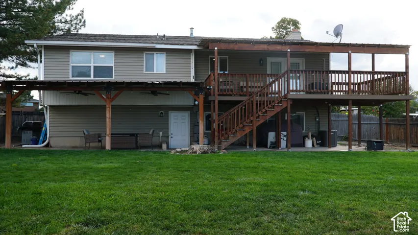 Exterior featuring horizontal siding, expansive wood-framed multi-level deck, covered patio space, and fenced backyard