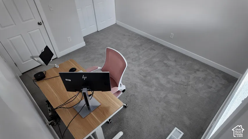 Neutral carpeting, crisp wall paint, and dual-panel interior doors