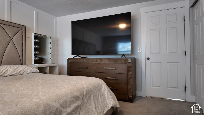 Board-and-batten wall detailing, wall-to-wall carpeting, and a four-panel interior door