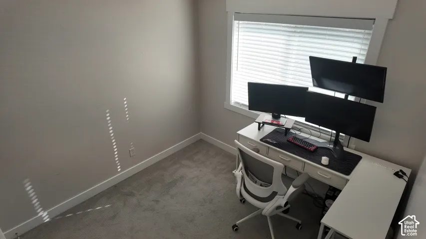 Neutral wall tones, carpeted flooring, and window featuring horizontal blinds