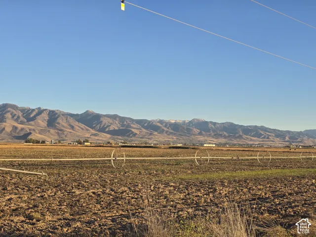 Open acreage featuring mountain backdrops and irrigation infrastructure