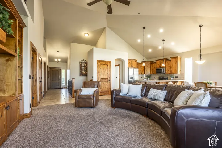 Vaulted ceilings, custom built-in wood shelving, arched doorways, pendant lighting, and natural wood cabinetry
