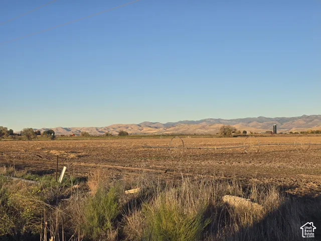 Expansive acreage featuring flat, open terrain and prominent mountain range scenery