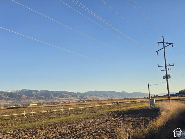 Expansive rural acreage featuring mountain scenery and an irrigation pivot system