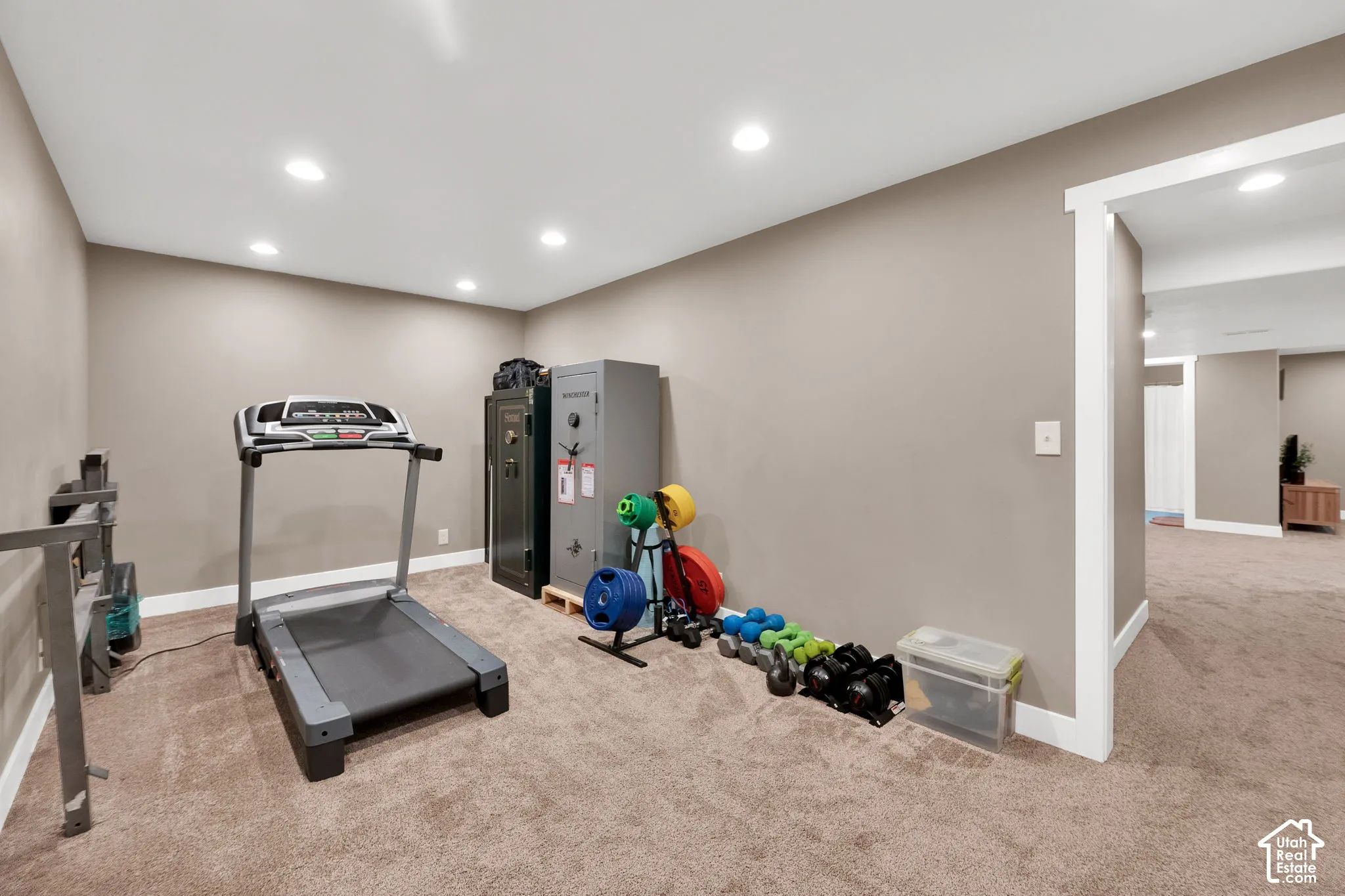 Neutral-toned room featuring recessed ceiling lighting, wall-to-wall carpeting, and white door trim