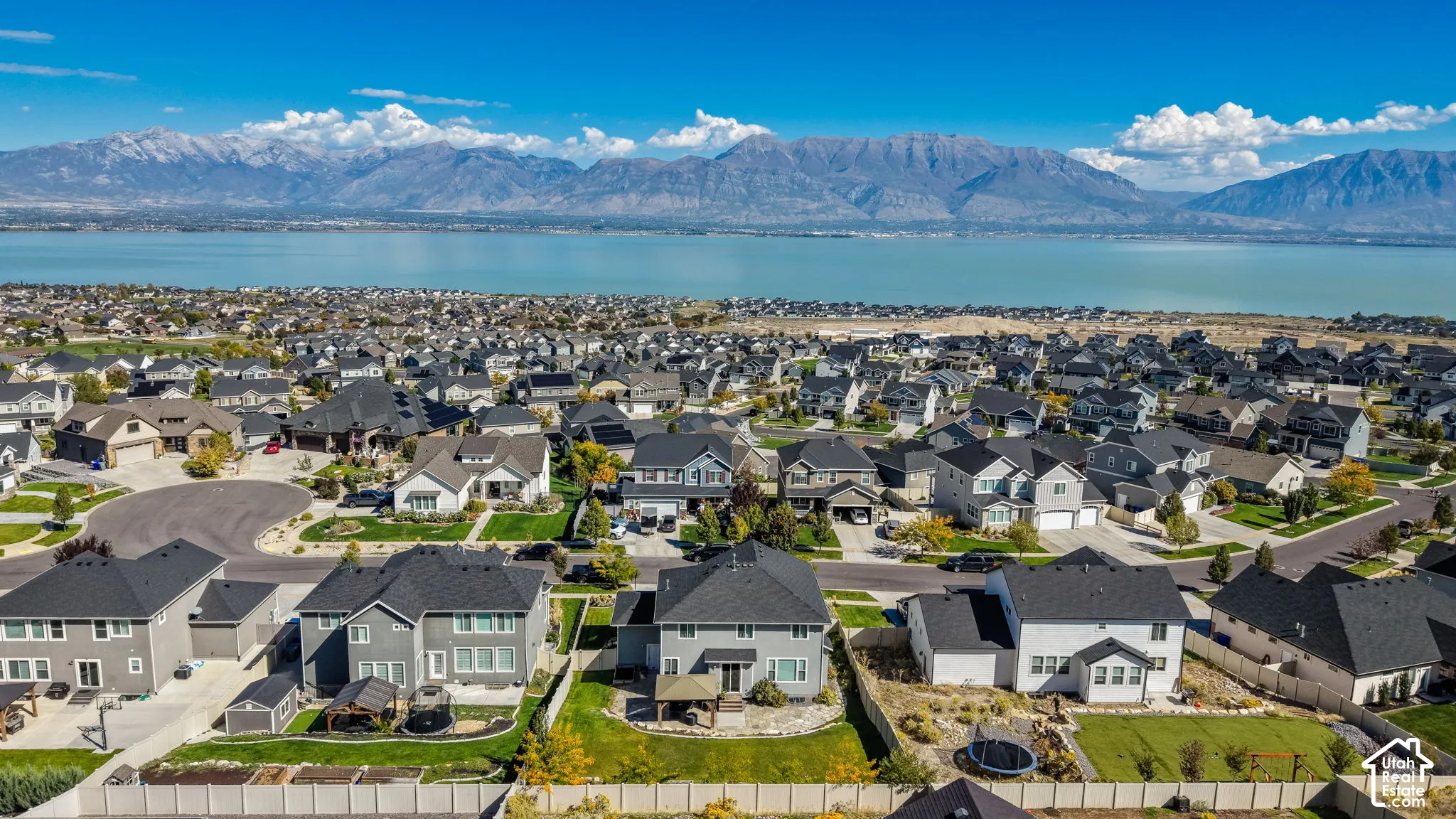 Aerial perspective featuring residential structures and expansive mountain and lake scenery