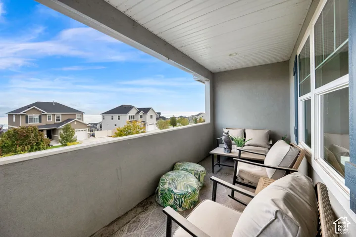 Covered balcony featuring stucco walls, recessed lighting, and a white beadboard ceiling