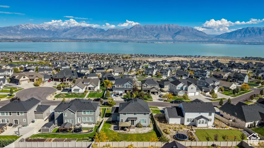 Aerial perspective featuring residential structures and expansive mountain and lake scenery