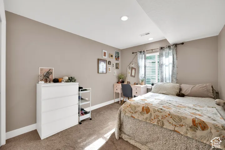 Neutral-toned walls, recessed lighting, and wall-to-wall carpeting
