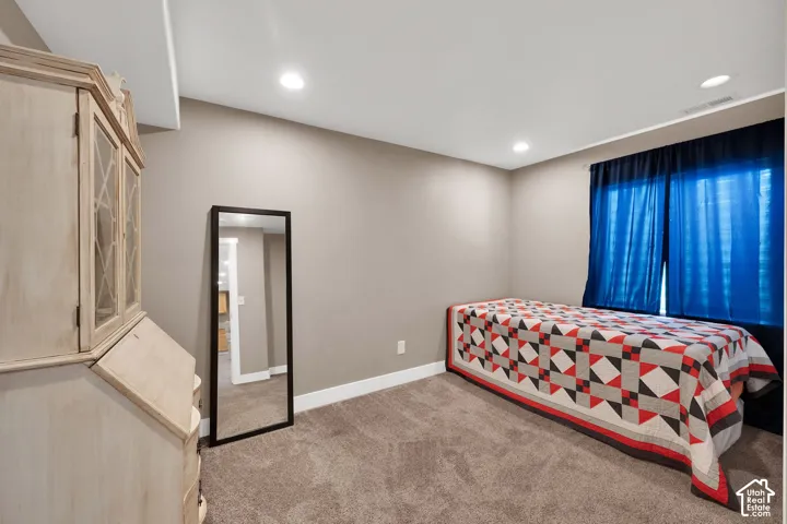 Neutral wall tones complemented by wall-to-wall carpeting and recessed ceiling lighting