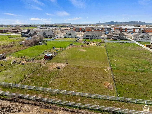 Expansive lot featuring perimeter fencing, level topography, and mountain backdrops